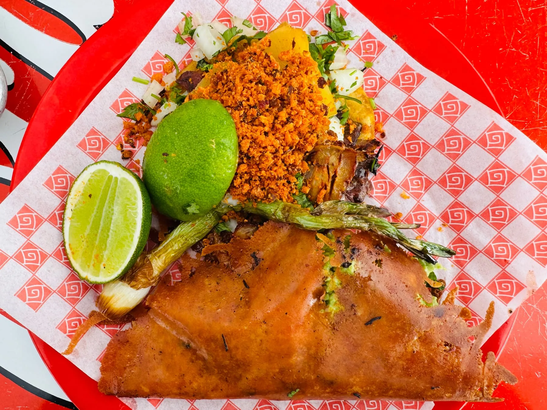Crisped birria quesadilla with limes and charred jalapeño